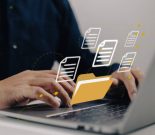 Uploading documents from folder. Open File folder with flying blank documents with laptop computer. Data transfer backup, File Sharing, Document Transferring concept.